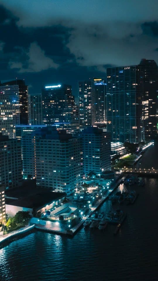 Miami high-rises and the waterfront at night from a drone